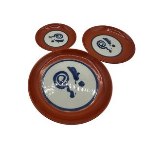 This is a Japanese Arita ware plate with a persimmon red glaze.